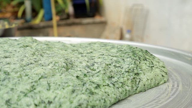 Green beewax rice cake dough on a tray