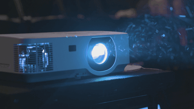Projector that emits bright light in dark room.