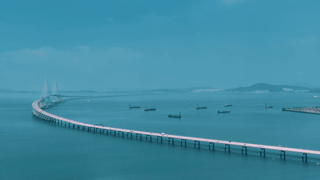 Long bridge over calm sea.