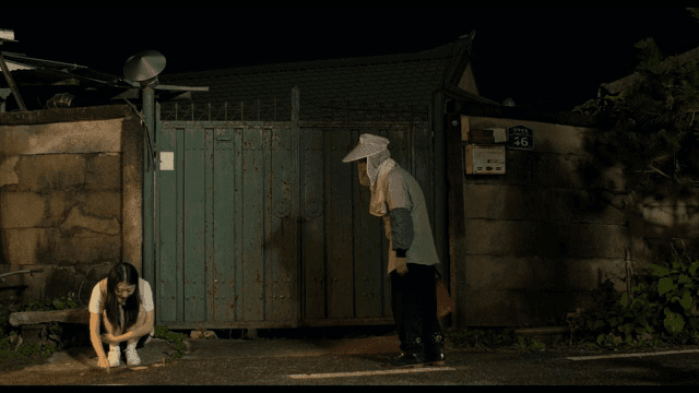 School girl talking to someone who was waiting at the door at night