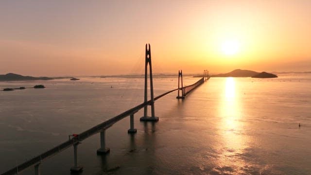 Bridge over the sea at sunset