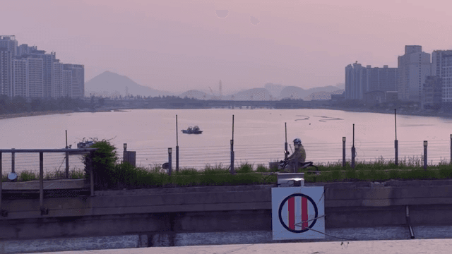 다리 위에서 스쿠터를 타는 사람