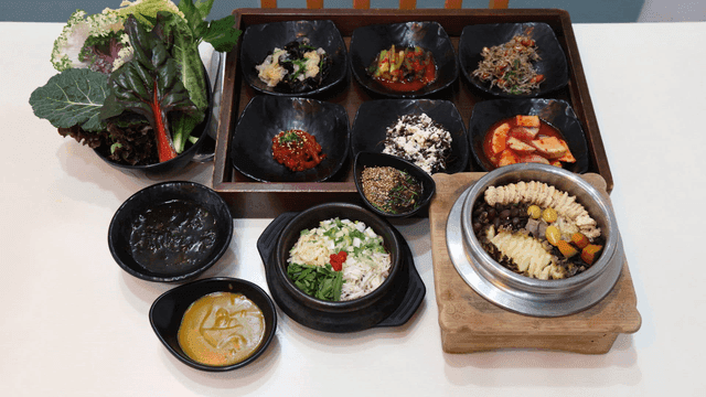Variety of pots and side dishes of soybean paste on table