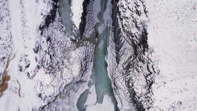 Snow-covered canyon with a frozen river