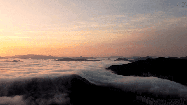 Mountains covered in clouds at sunrise