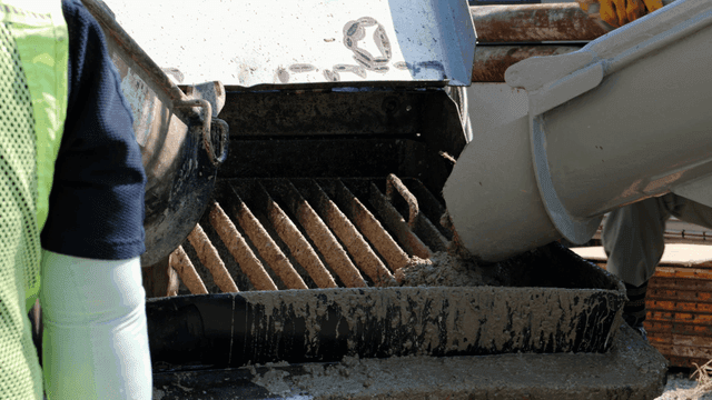 Concrete being poured into a mixer