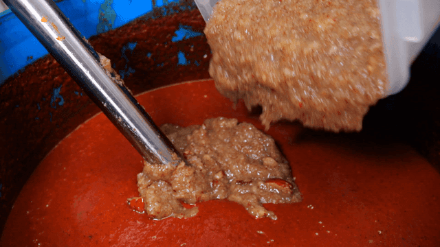 Sight of ground dates mixing into red seasoning