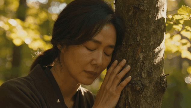 Woman embracing a tree in the forest while breathing deeply