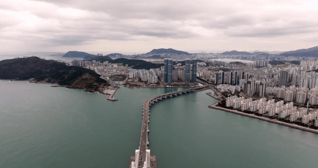 Sprawling cityscape with a bridge over sea