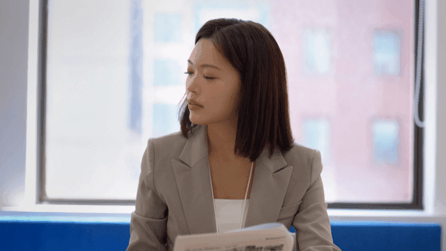 Woman reading documents in office
