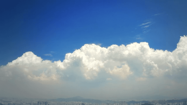 Bright clouds over a city skyline
