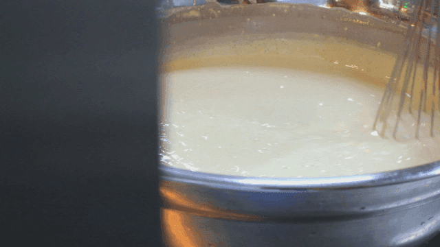 Batter being mixed in a metal bowl