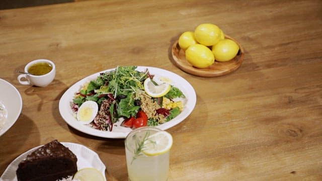 Pasta, salad and cake on a wooden table