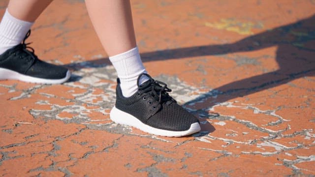 Person running on a cracked orange surface