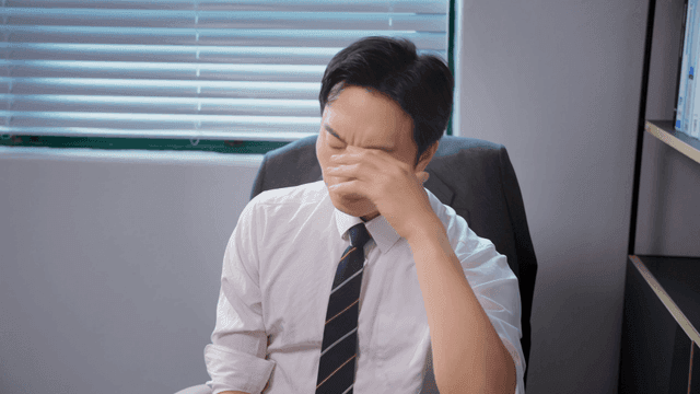 Man in office deep in thought