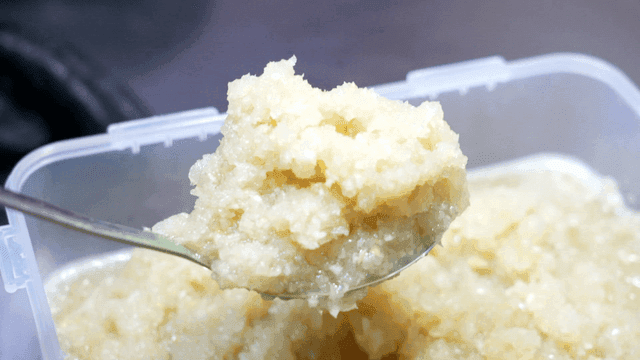 Minced garlic scooped out of container