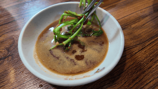 Chopsticks for dipping codfish soup water parsley in soy sauce