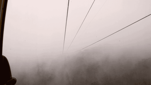 Cable car ride through misty mountains