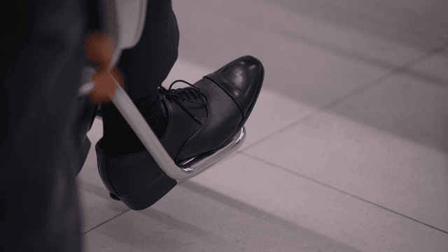 Person wearing formal shoes sitting indoors