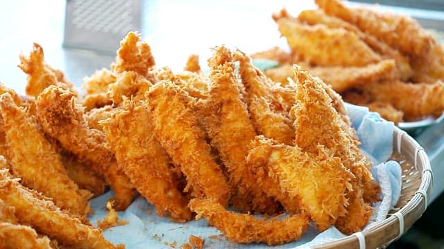 Freshly fried crispy fish fillets in the basket