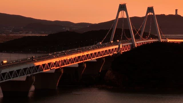 Bridge at sunset with cars passing by