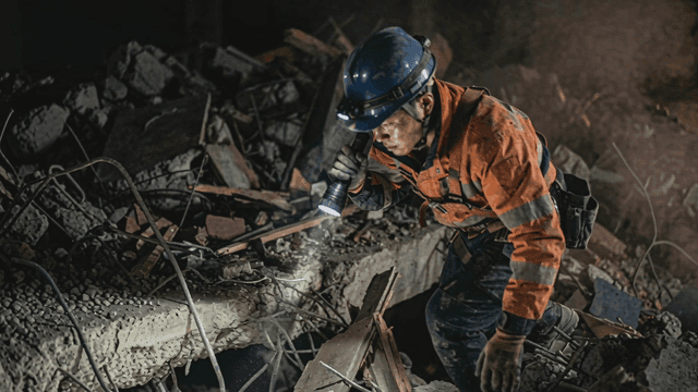 Rescue worker searching through rubble