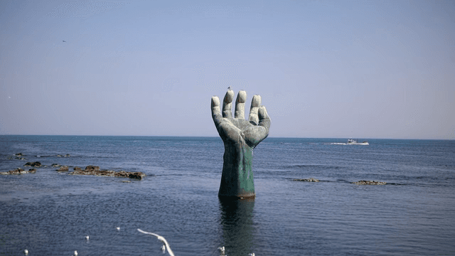Large hand sculpture in the sea