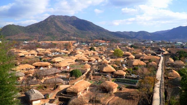 Rural village with thatched-roof houses in the mountains