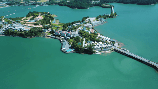 A scenic island with a bridge and buildings