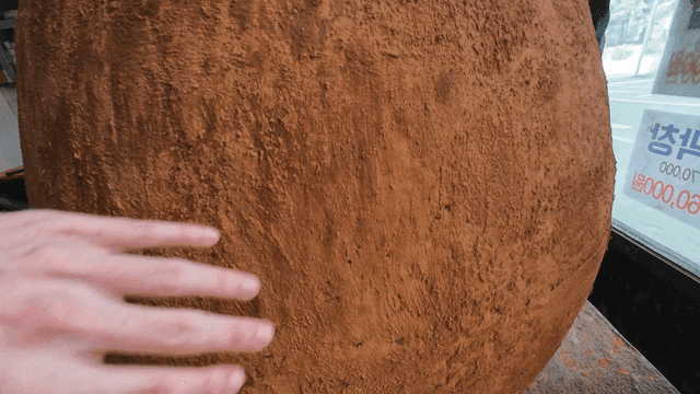 Hands touching large jar