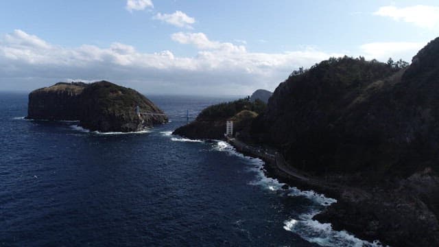 Aerial View of Coastal Road by Rugged Cliffs