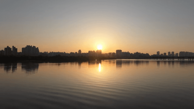 도시 스카이라인과 강 위의 일몰