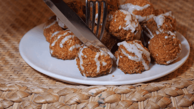 Coconut rocher being cut on plate