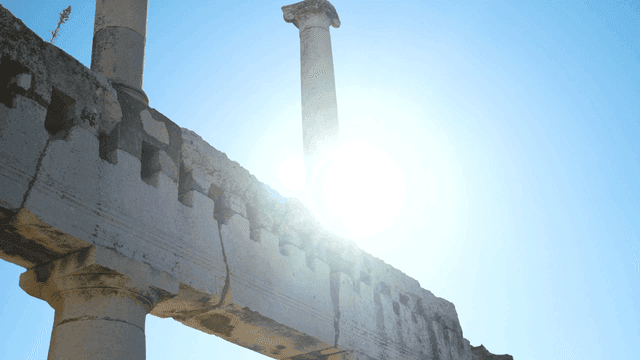 Ancient stone columns under a clear sky
