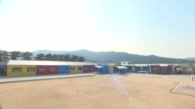 Colorful school playground with mountain backdrop