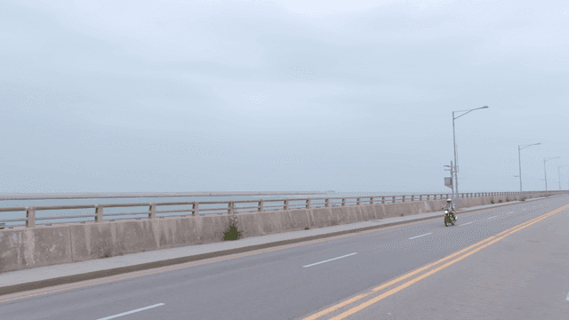 Motorcyclist riding along a coastal road