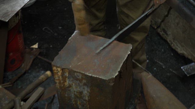 Craftsman forging a metal blade