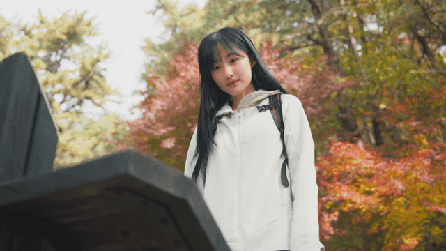 Woman checking mountain sign in autumn forest