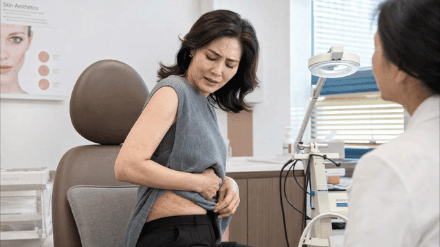 Woman showing her skin condition to doctor