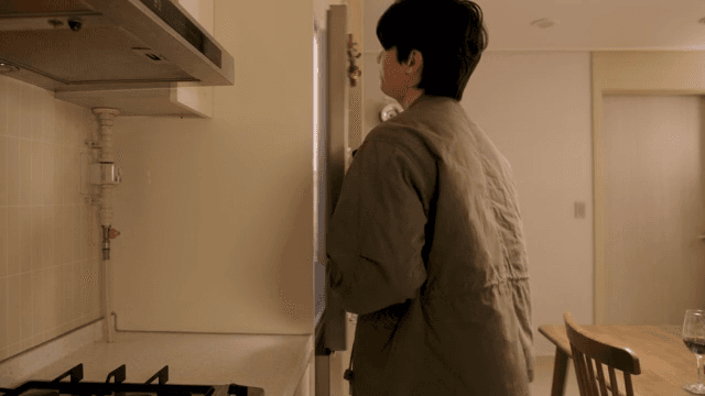 Man talking to woman in kitchen