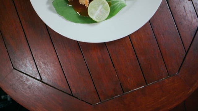 Delicious fried fish with thick sauce and lime