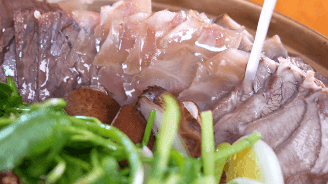Boiled beef slices hot pot filled with fresh ingredients and broth