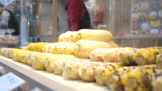 Steaming corn on display at a market