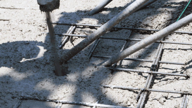 Workers pouring concrete at a construction site