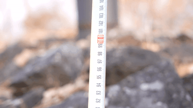 Measuring tape on rocky terrain