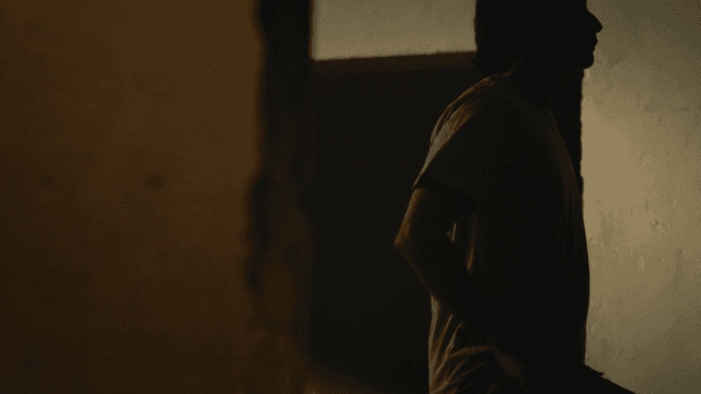 Silhouette of person sitting in dark room