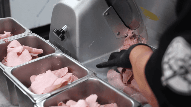 Kitchen slicing ham with meat slicer