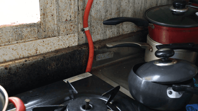 Kitchen stove with pots and pans full of grease