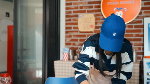 Woman cleaning a table in a pizza shop