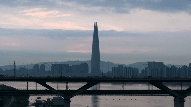 City skyline with a tall tower at dusk